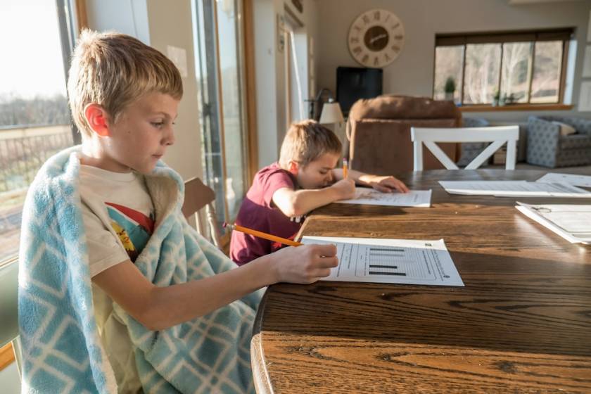 boys doing homework at table